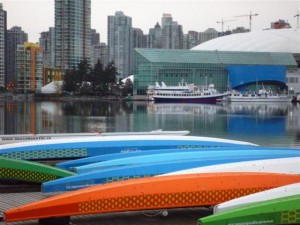 Dragonboats on dock in Southeast False Creek with Downtown Vancouver in background